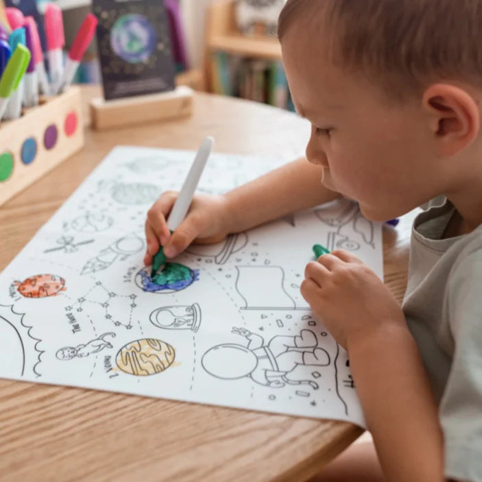 Hey Doodle Outer Space colouring mat, being coloured in by a boy.